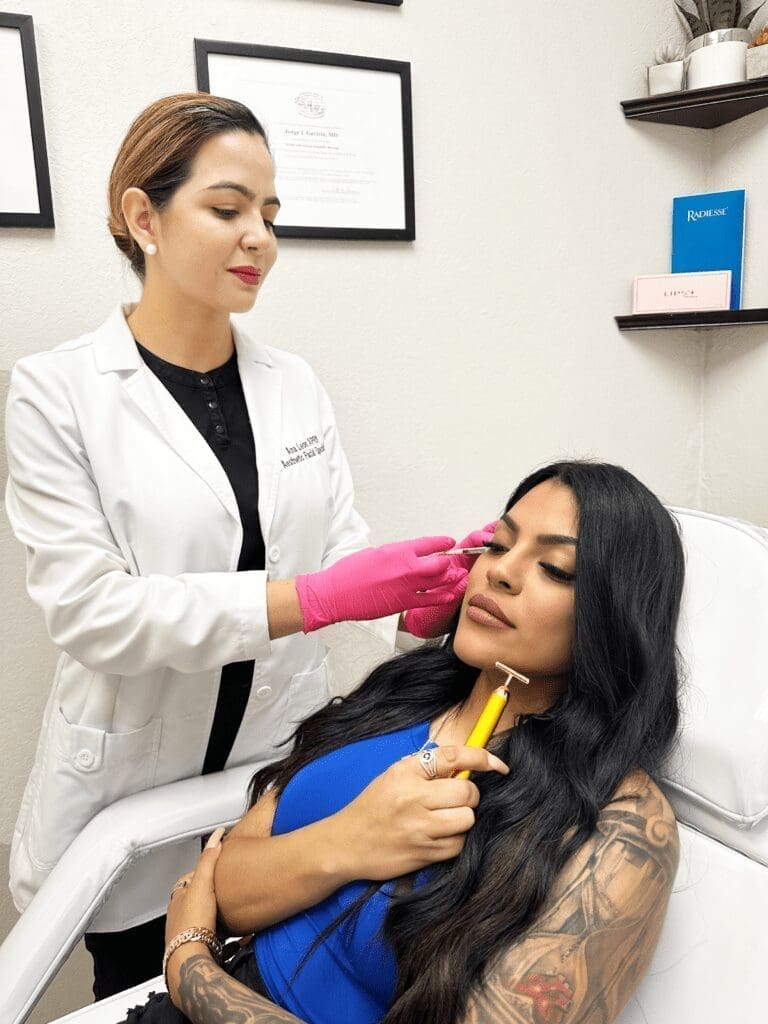 Dermatologist Applying Botox Cosmetics Facial Treatment On Patient Holding A Facial Roller To Her Face