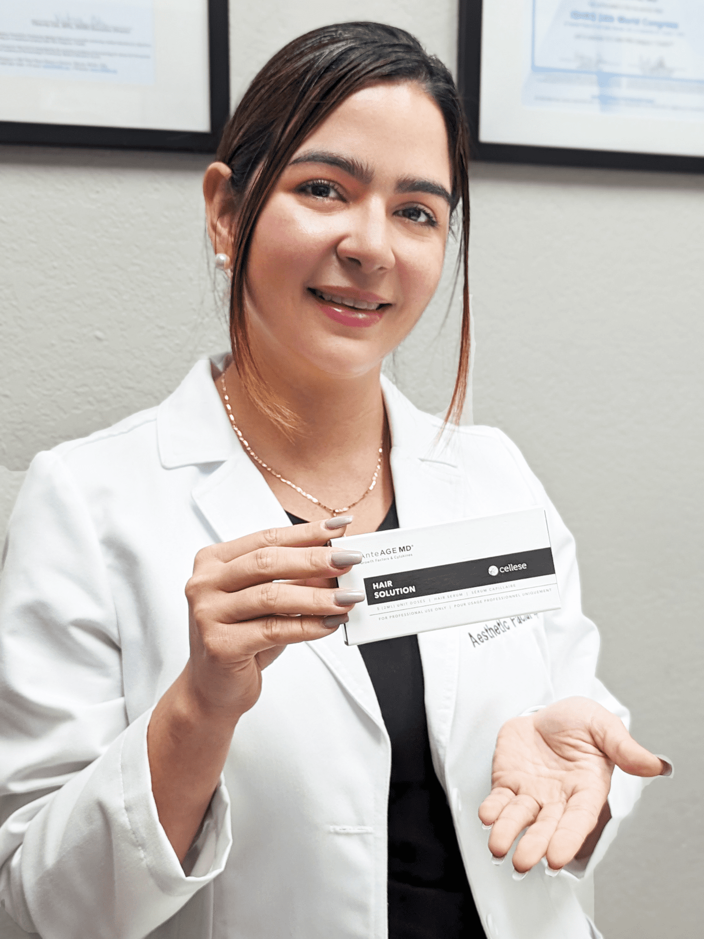 Specialist Wearing A Doctor Coat Shows Stem Cell For Hair Loss Treatment Packaging Used At Danik MedSpa