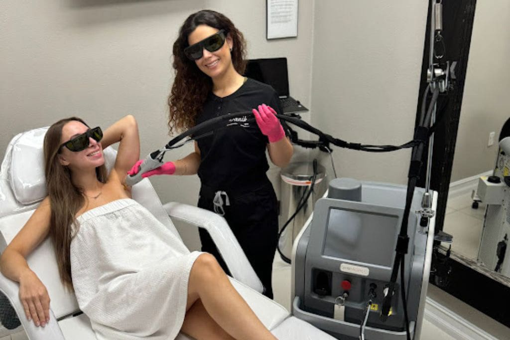 Specialist Wearing Black Uniform And Pink Gloves Applies Best Laser Hair Removal Treatment On Woman Armpit