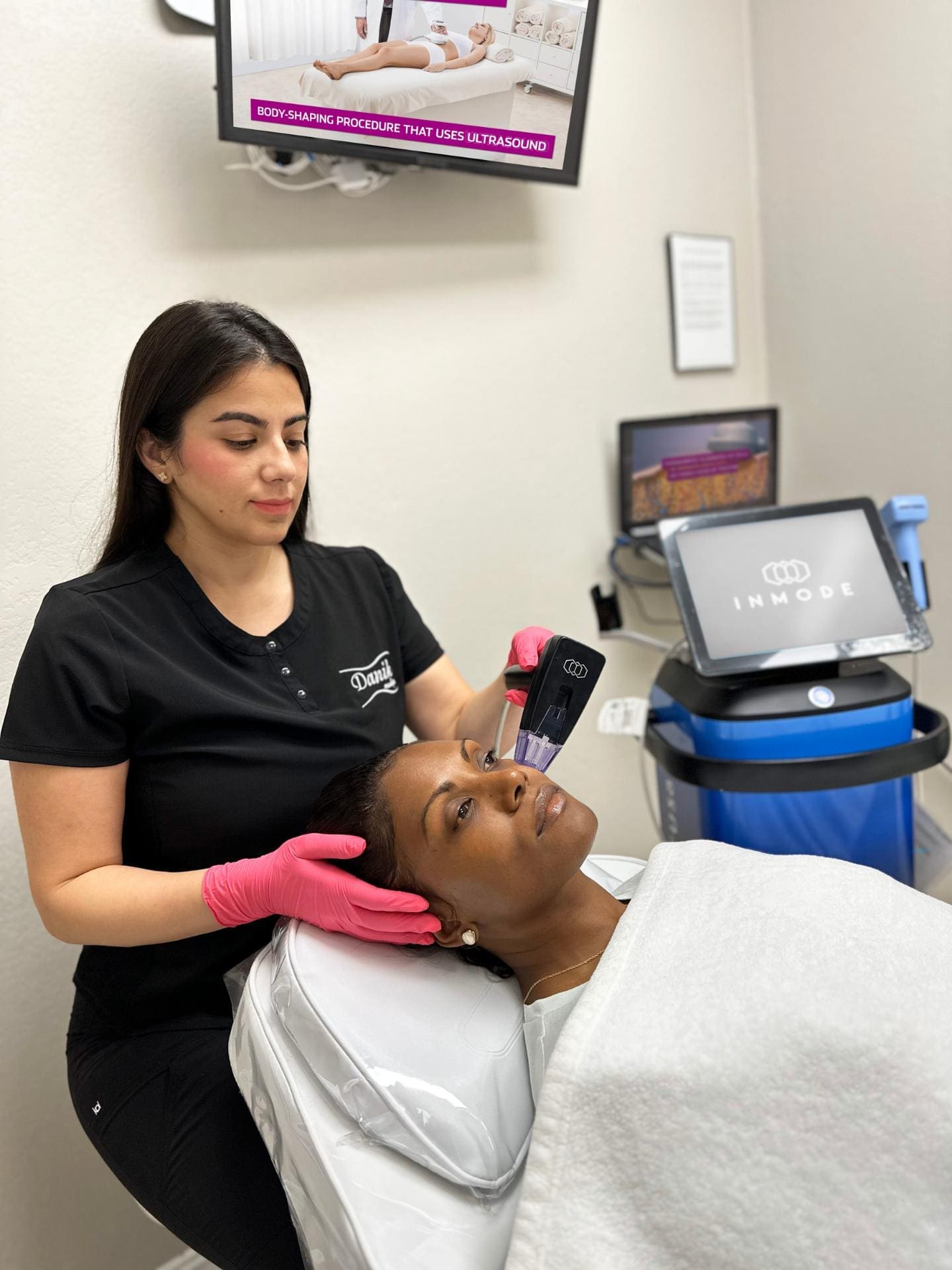 Specialist Applying Morpheus8 Facial Treatment With Microneedling Equipment to Patient In A White Towel