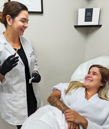 Specialist Wearing Doctor Robe Black Uniform And Black Gloves With A Syringe In Hand Ready To Apply Weight Loss Injections To Patient