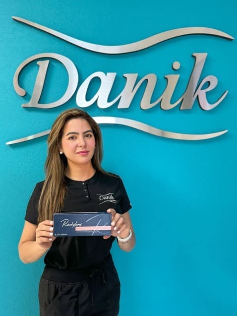 Danik MedSpa specialist holding Restylane® Kysse product box for lip enhancement.