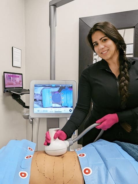 Danik MedSpa specialist using UltraShape® device for fat reduction treatment.