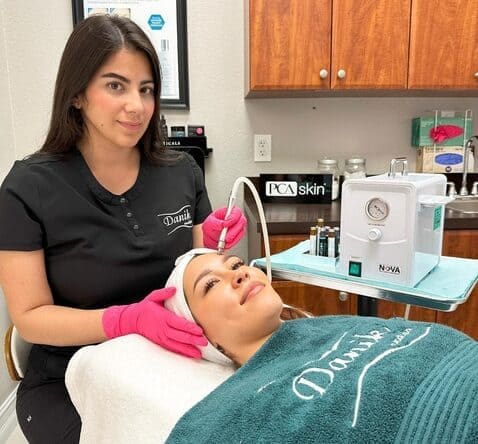 Specialist performing microdermabrasion treatment on a client at Danik MedSpa.